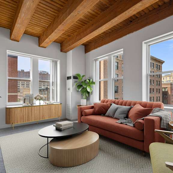 a living room with a red couch and a large window