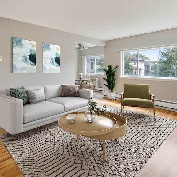 a living room with a couch and a coffee table at ames lake neighborhood apartments, st. paul