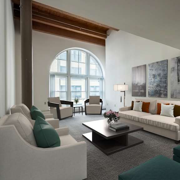 a living room with white furniture and a large arched window at parkside apartments, st. paul, minnesota