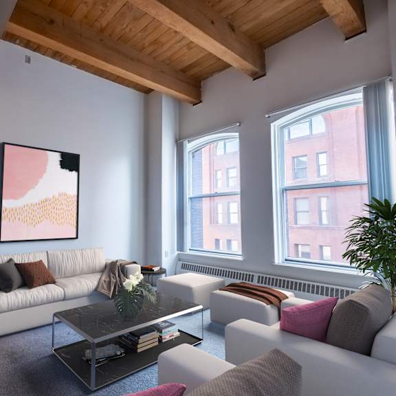 a living room with white couches and a coffee table