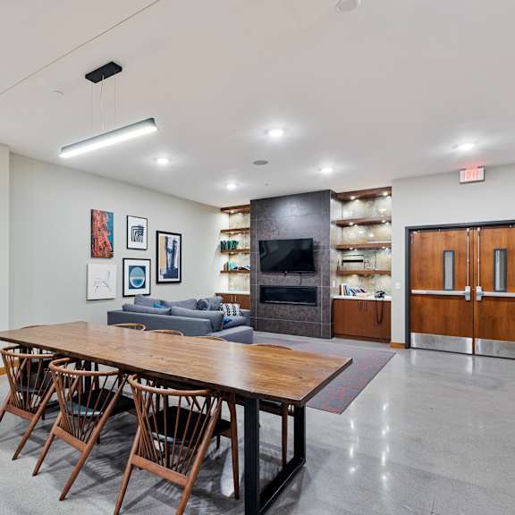 a large dining room with a wooden table and chairs at press house apartments, st paul, 55101