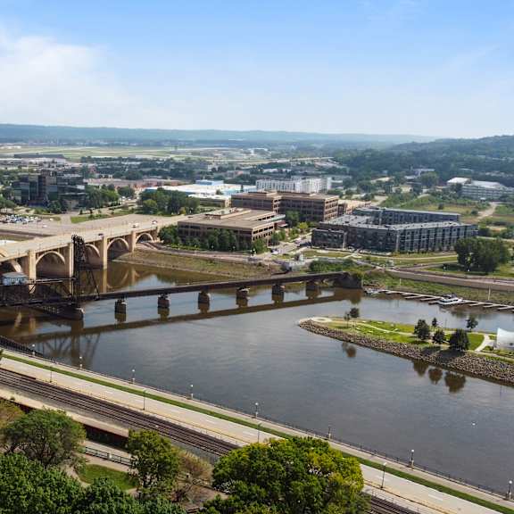 an aerial view of a bridge over a river in a city at press house apartments, st paul, minnesota