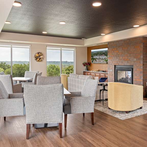 clubroom with fireplace at the quill 55+ apartments, hastings, minnesota