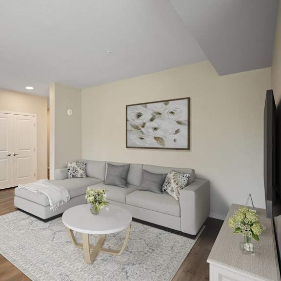 a living room with a couch and a table at the quill 55+ apartments, hastings, 55033