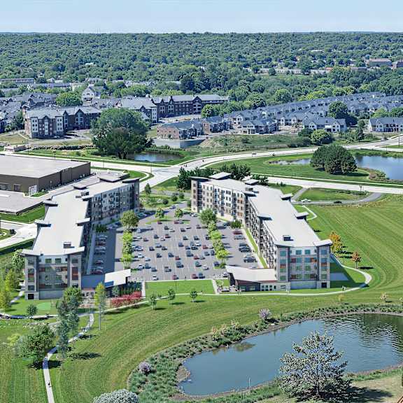 modern apartment buildings with central parking lot at reserve at settlers ridge apartments, woodbury