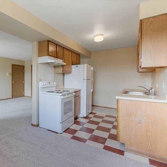 a kitchen with a white fridge and a checkered floor at ames lake neighborhood apartments, minnesota, 55106