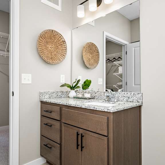 a bathroom with a vanity and a mirror.