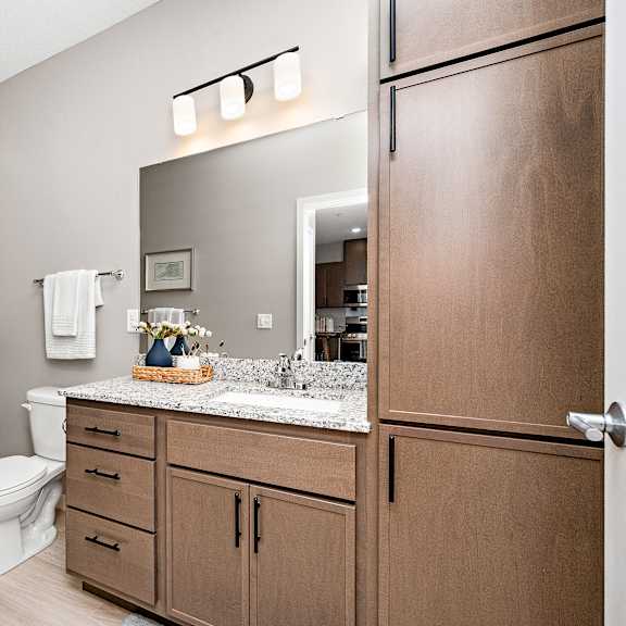 full bathroom with tub shower and linen cabinet at reserve at settlers ridge apartments, woodbury, minnesota