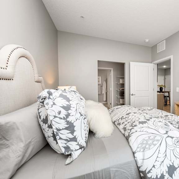a bedroom with a large bed and a mirror on the wall.