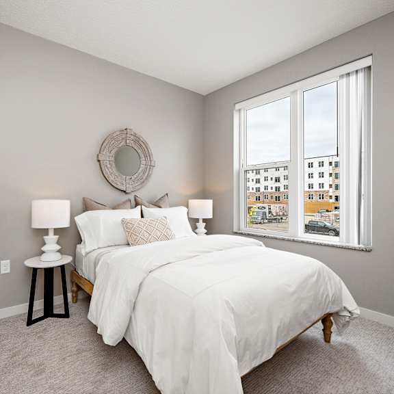 bedroom with large window and neutral decor at reserve at settlers ridge apartments, woodbury, 55129