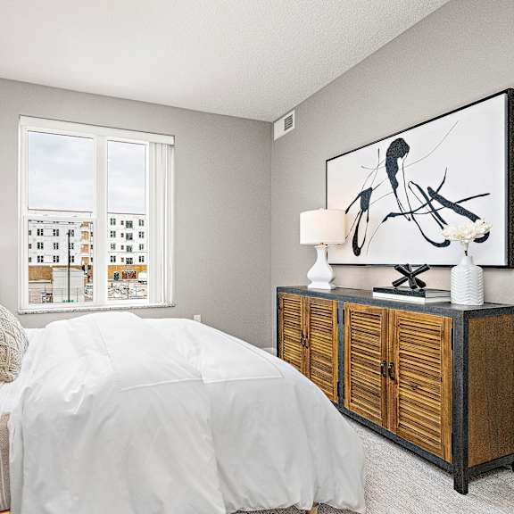 a bedroom with a large bed and a wooden cabinet.