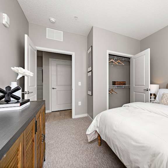 bedroom with walk-in closet and gray walls at reserve at settlers ridge apartments, woodbury
