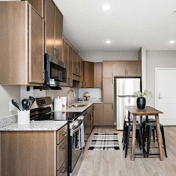 a kitchen with wooden cabinets and a black stove top oven.