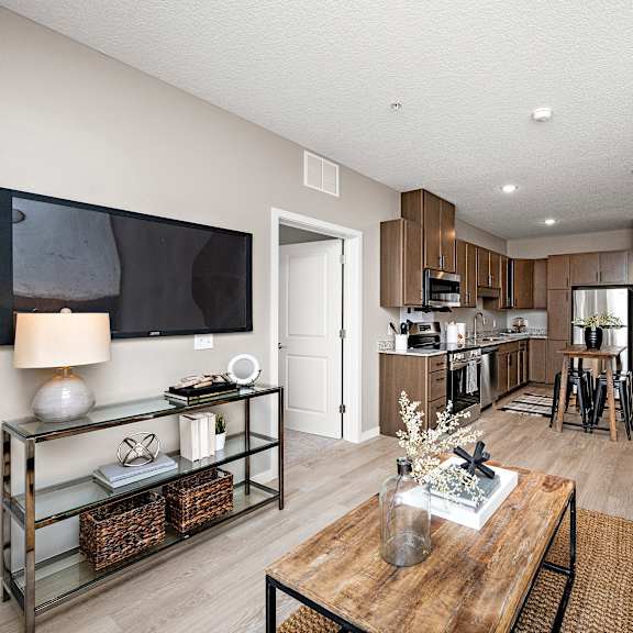 a modern living room with a flat screen tv mounted on the wall.