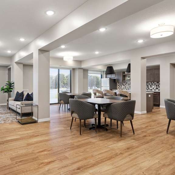 a modern living room with a dining table and chairs at sonder point 50+ apartments, brooklyn center, mn