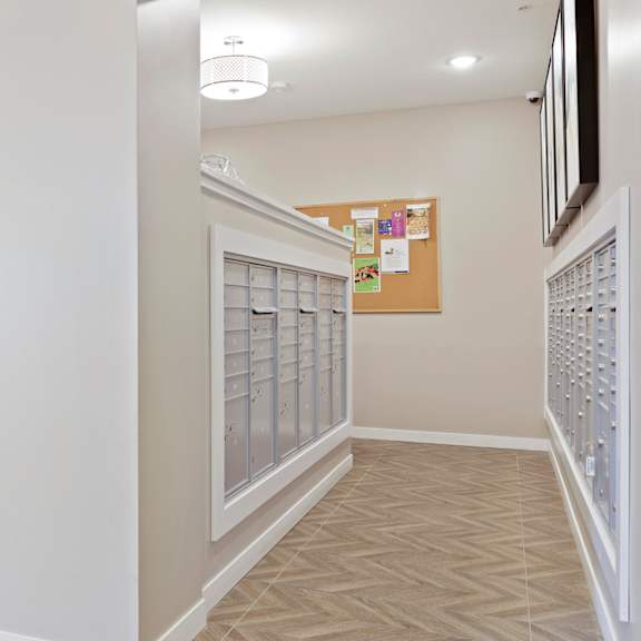 a hallway with a bulletin board on the wall at sonder point 50+ apartments, brooklyn center, minnesota