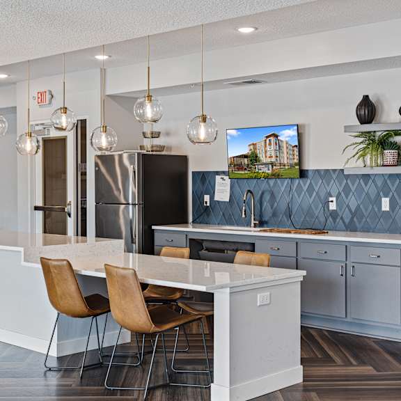 a kitchen with a white counter top and blue cabinets