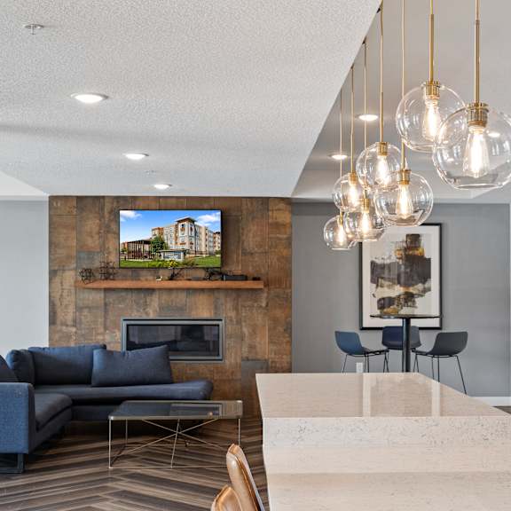 a living room with couches and a table and a kitchen