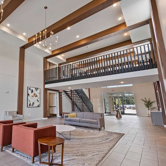a lobby with couches and chairs and a staircase