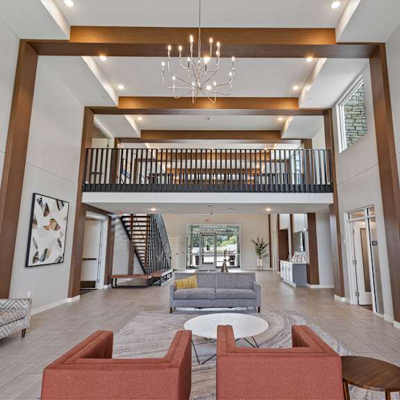 a lobby with couches and chairs and a chandelier