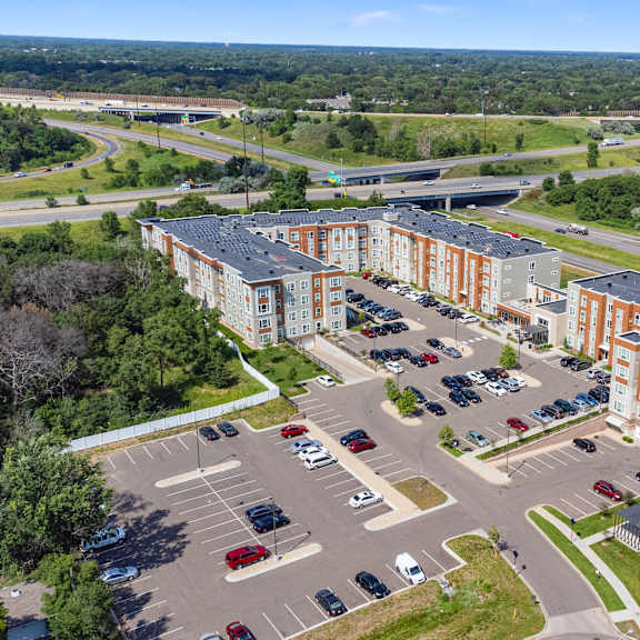 an aerial view of an apartment complex and parking lot