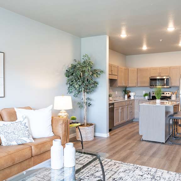 a living room and kitchen with a couch and a table at technology park apartments, rochester, 55901