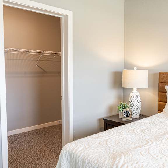 a bedroom with a bed and a closet at technology park apartments, rochester, mn