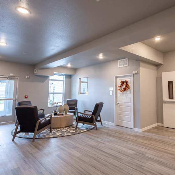 the clubhouse at the champion apartments has a living room and kitchen at technology park apartments, rochester, mn