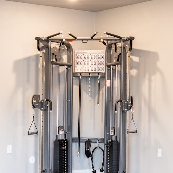 a fitness room with cardio equipment in a home gym at technology park apartments, rochester, 55901