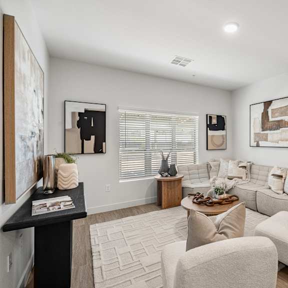 a living room with a white couch and a coffee table.