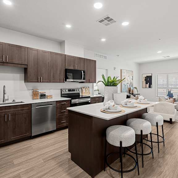 a modern kitchen with a dining area and a couch.