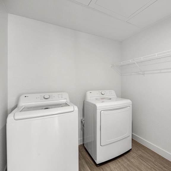 washer and dryer in a white room.
