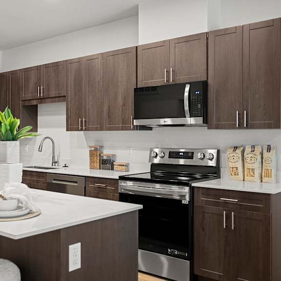 a kitchen with brown cabinets and white countertops.