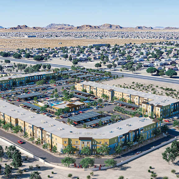 a large, modern building complex is surrounded by a parking lot and a residential neighborhood.