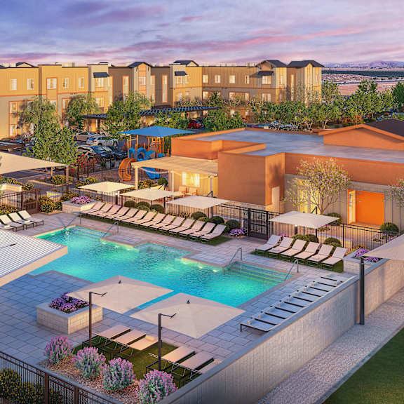 a large outdoor swimming pool surrounded by lounge chairs and umbrellas.