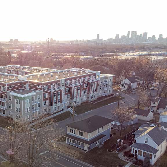 an aerial view of a large building with a city in the background