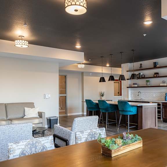 a living room and kitchen with a table and chairs