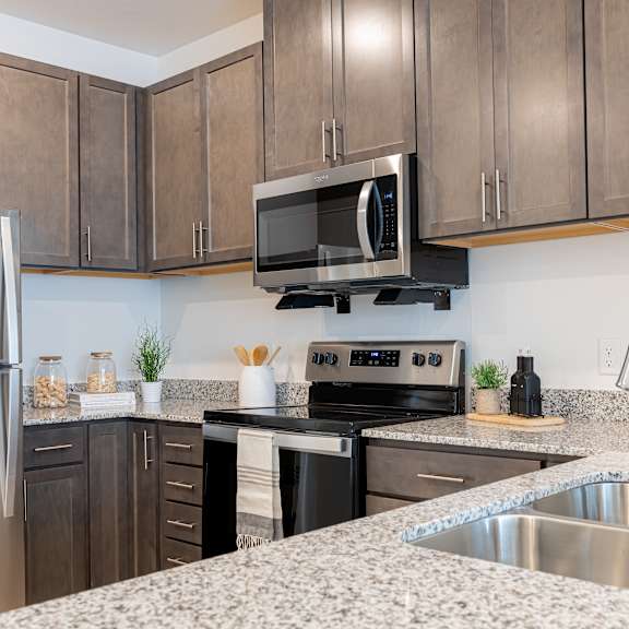 a kitchen with granite counter tops and stainless steel appliances