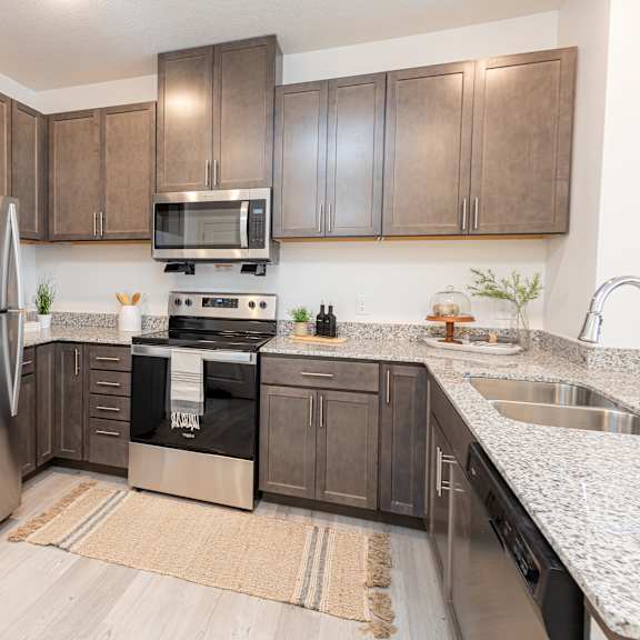 a kitchen with stainless steel appliances and wooden cabinets