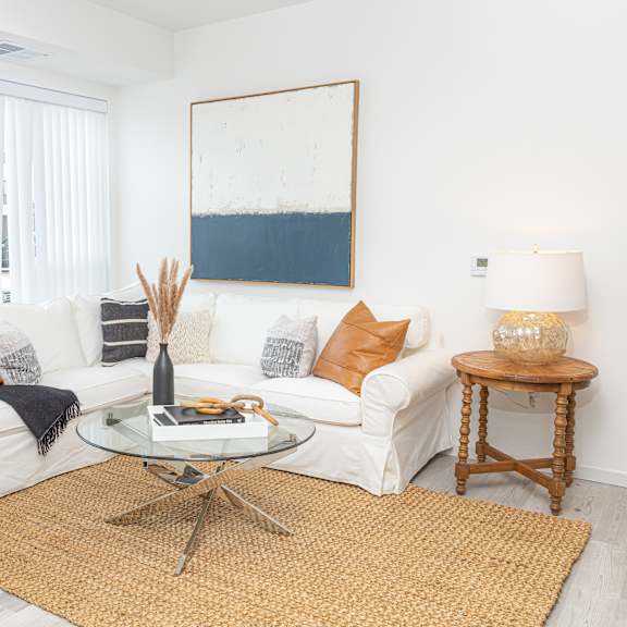 a living room with a white couch and a table