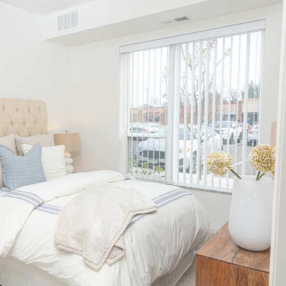 a bedroom with a large bed and a large window