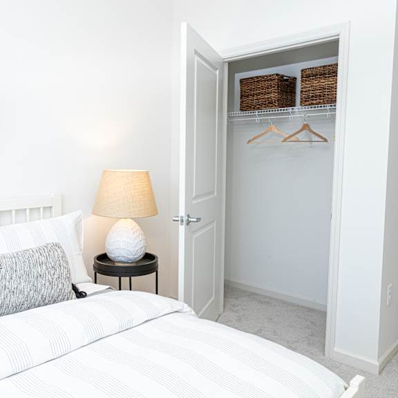 a bedroom with a bed and a closet with a white door