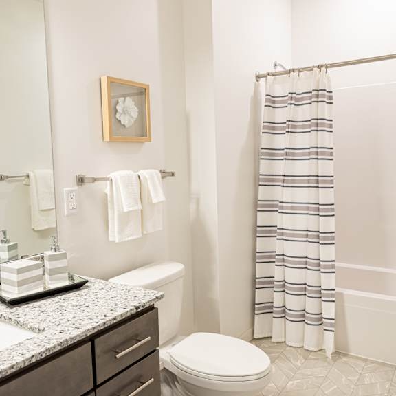 a small bathroom with a toilet and a shower and a sink