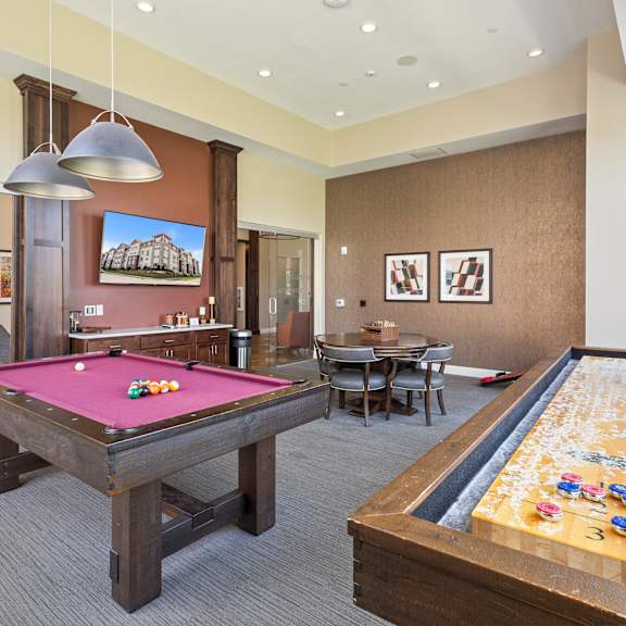 a game room with two pool tables and a billiard table at the winslow 62+ apartments, west st paul