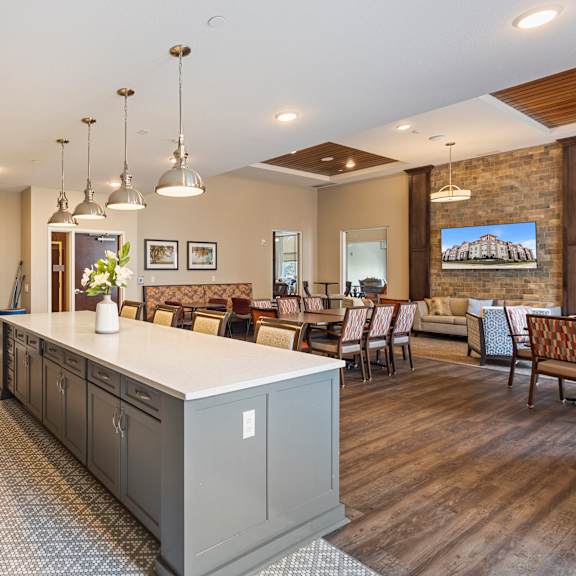 a large kitchen with a center island and a dining room at the winslow 62+ apartments, west st paul