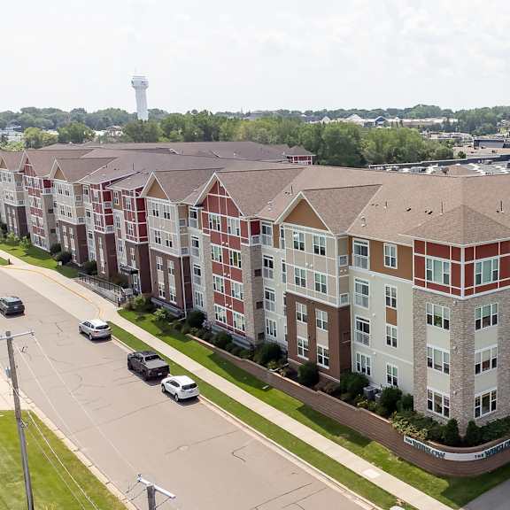 an aerial view of an apartment building on a city street at the winslow 62+ apartments, minnesota, 55118