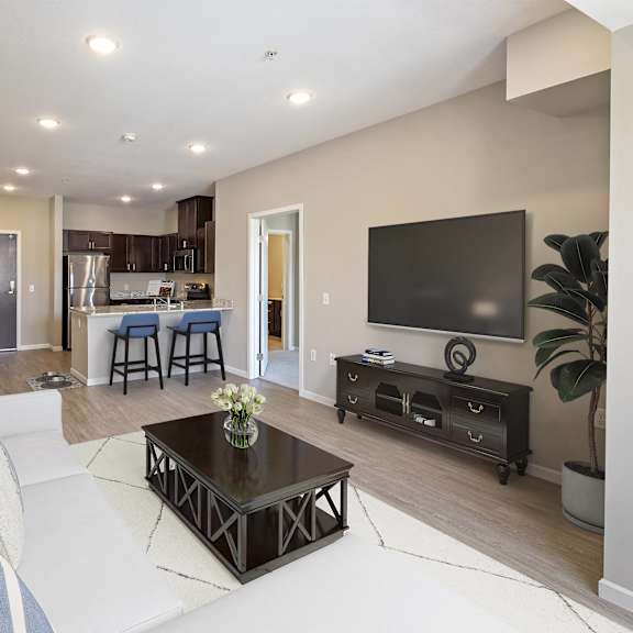 a living room with a couch and a television at the winslow 62+ apartments, minnesota