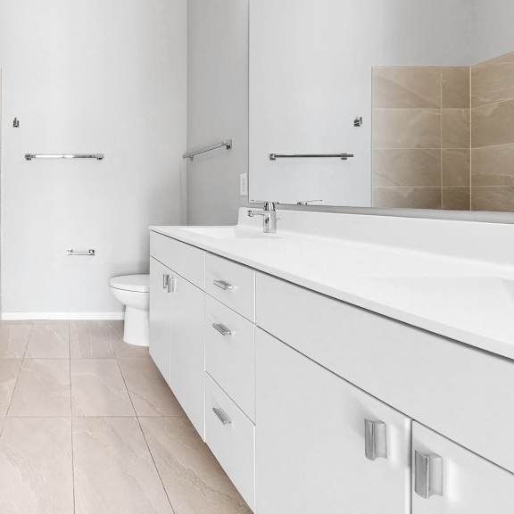 Thumbnail 9 of 12 A bathroom with a white tub, sink, and toilet.