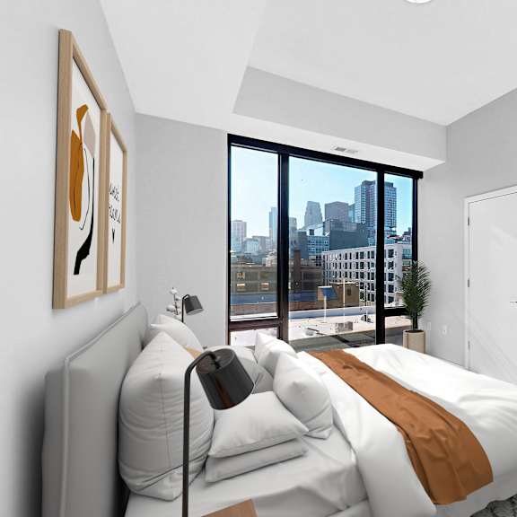 Thumbnail 6 of 12 A bedroom with a large bed and a city view through the window.