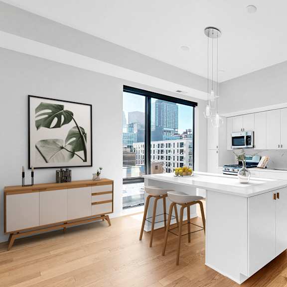 Thumbnail 3 of 12 A modern kitchen with a white island and stainless steel appliances.